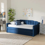 Navy blue Krease Upholstered Daybed with Trundle Bed in a bright room, perfect for stylish guest or kids' spaces.