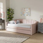 Blush pink Krease Upholstered Daybed with Trundle Bed in a soft-toned room, perfect for kids or feminine decor themes.