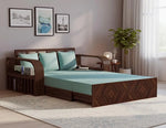 Wooden bed with teal bedding in a bedroom setting