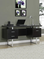 A solid mango wood study desk with brown finish and silver metal legs, featuring drawers and a space for a laptop, placed against a wall with framed pictures above it.