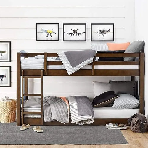 Wooden bunk bed with bedding and pillows in a room with framed pictures on the wall.